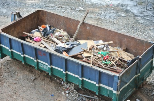 Personnel assessing commercial waste containers